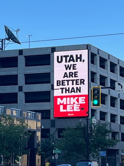 A light up sign that says Utah, we are better than Mike Lee