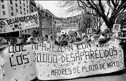 Madres De Plaza De Mayo protest: large banner decrying the disappearance of 30000 desaparacidos held by a dozen women, backed by hundreds of others